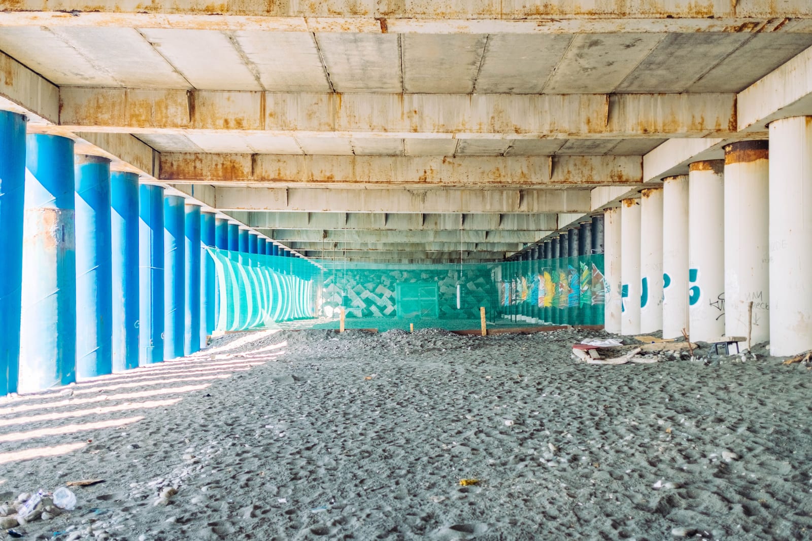 A steel pier bracket set against a poured foundation wall.